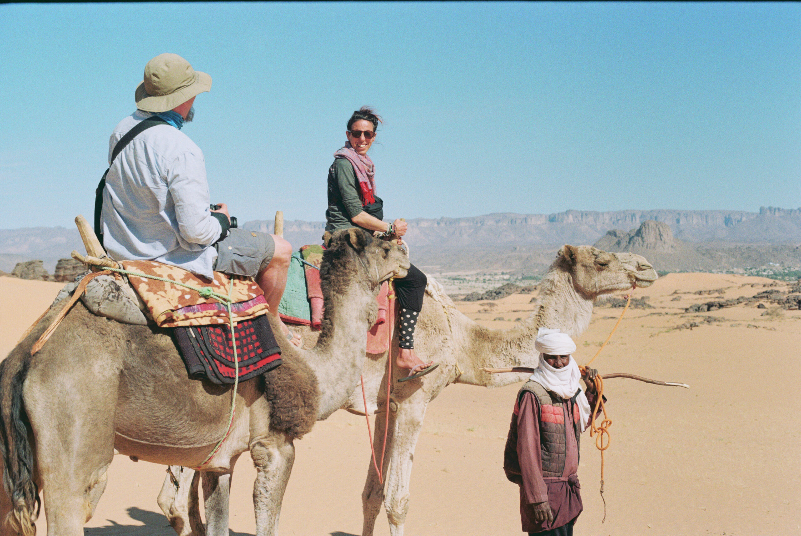 Camel ride in the Sahara desert, Algeria with sand dunes and traditional caravan