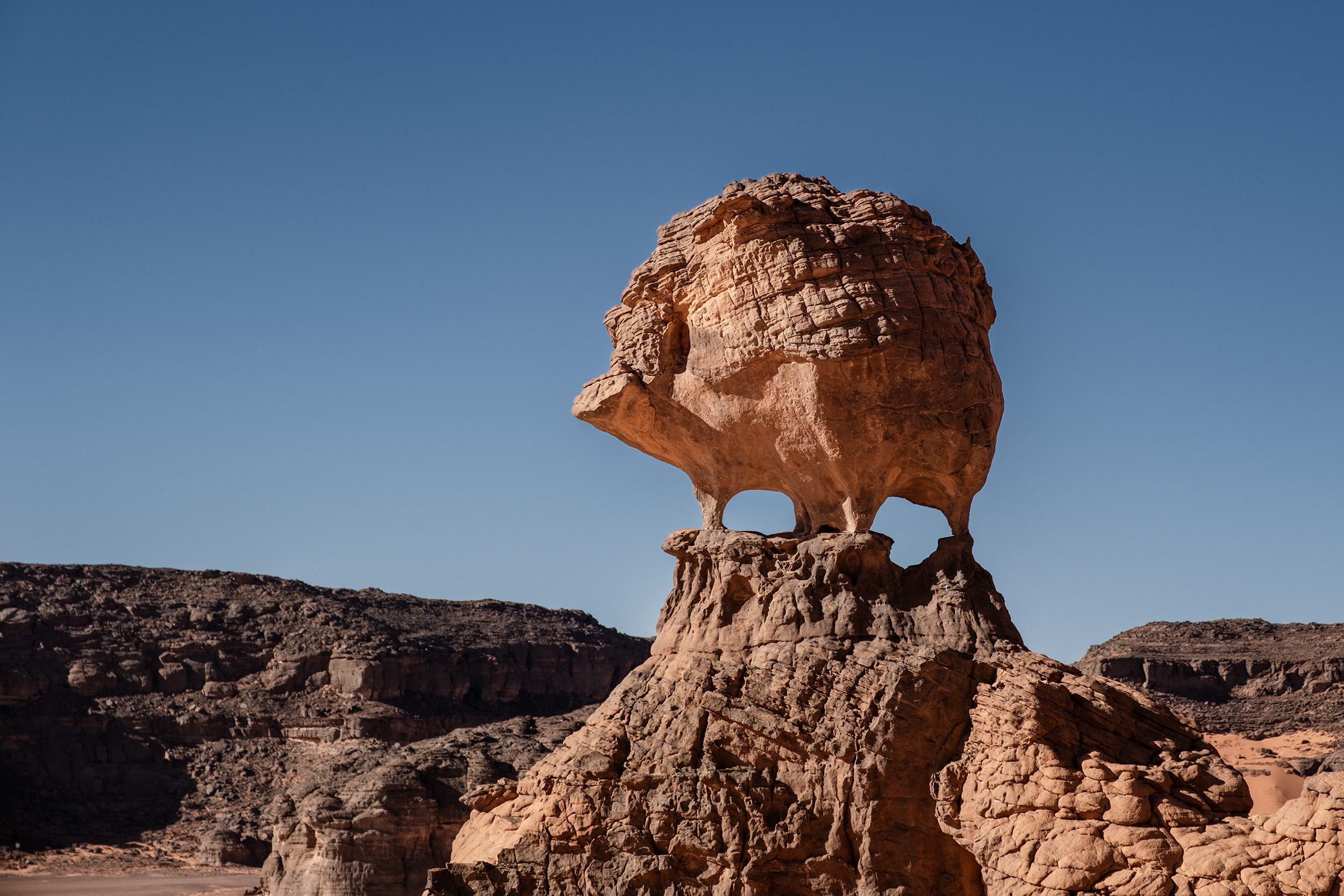 Red sand dunes in Tadrart Sahara, Algeria with dramatic formations