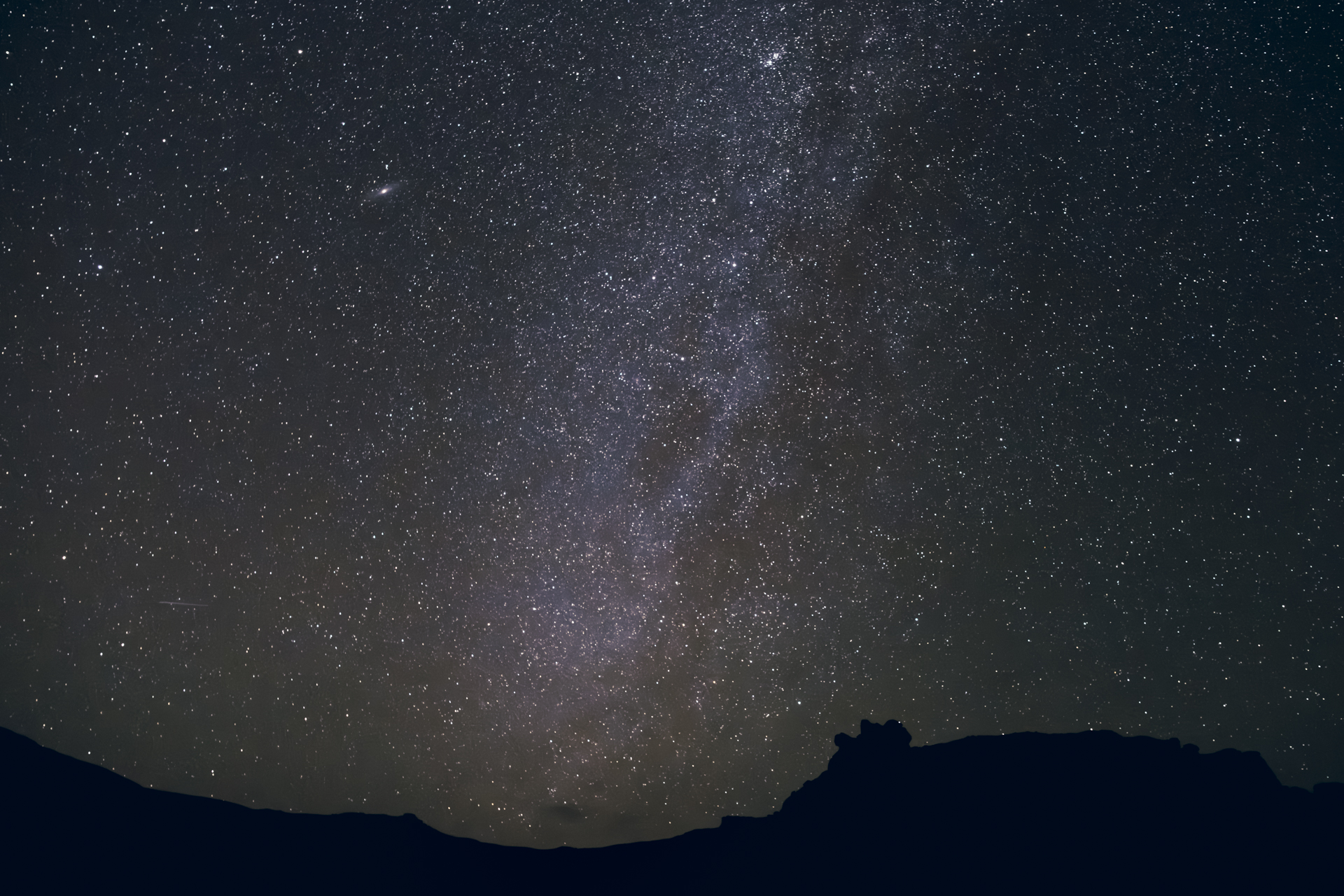 Starry night over Tadrart desert in Algeria with dunes under the Milky Way